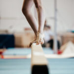 competition gymnastics exercises on balance beam girl gymnast